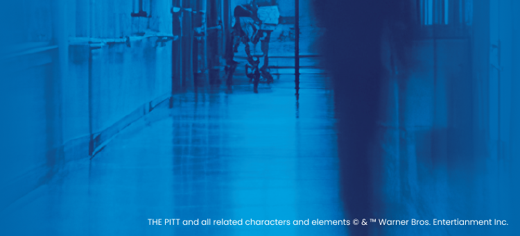 Blue-tinted hallway with people walking, blurred effect for The Pitt collection banner.