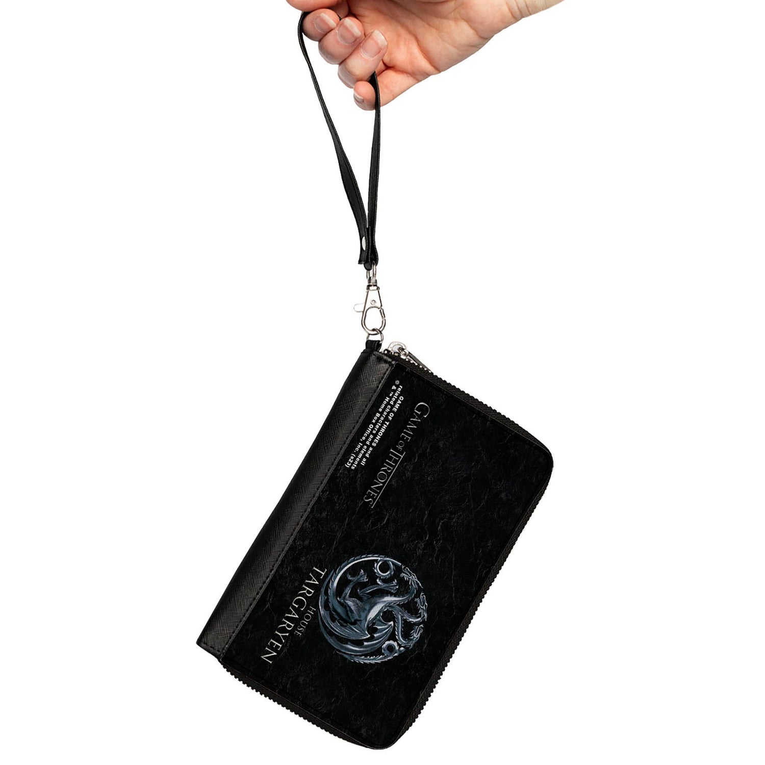 A hand holds a black Game of Thrones House Targaryen wristlet with a dragon sigil and text.