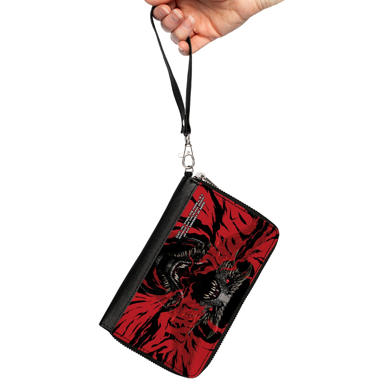 Hand holds a red and black wristlet wallet featuring two roaring dragons and visible copyright text.