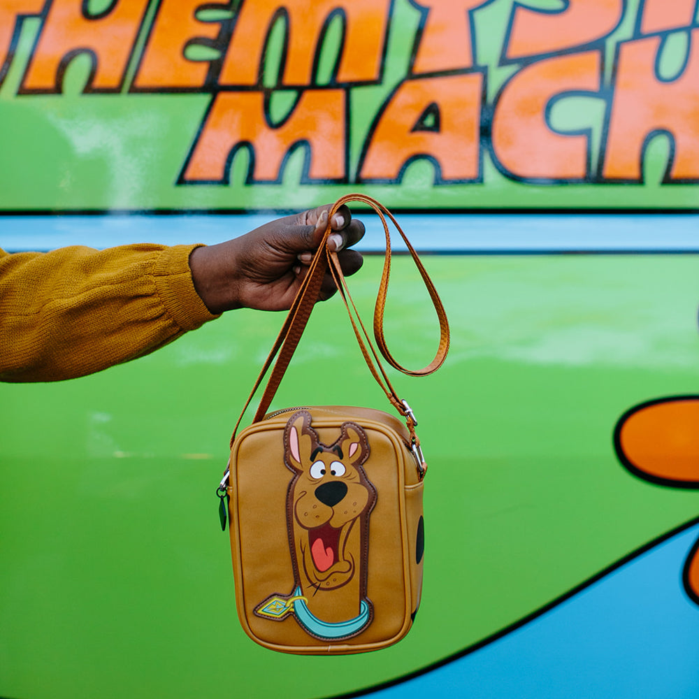 Model wearing Scooby-Doo crossbody bag with teal strap