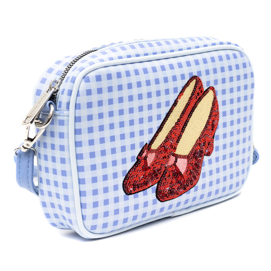 Close up of the shimmering red sequined ruby slippers and Toto graphic