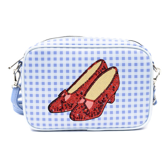 Front view of The Wizard of Oz blue crossbody bag with sequined ruby slippers and Toto